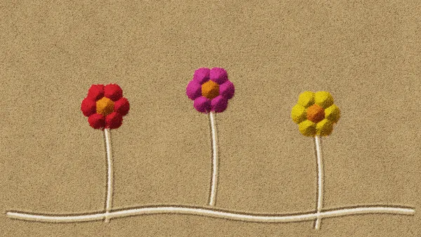 Coloured sand flowers on a glowing light table
