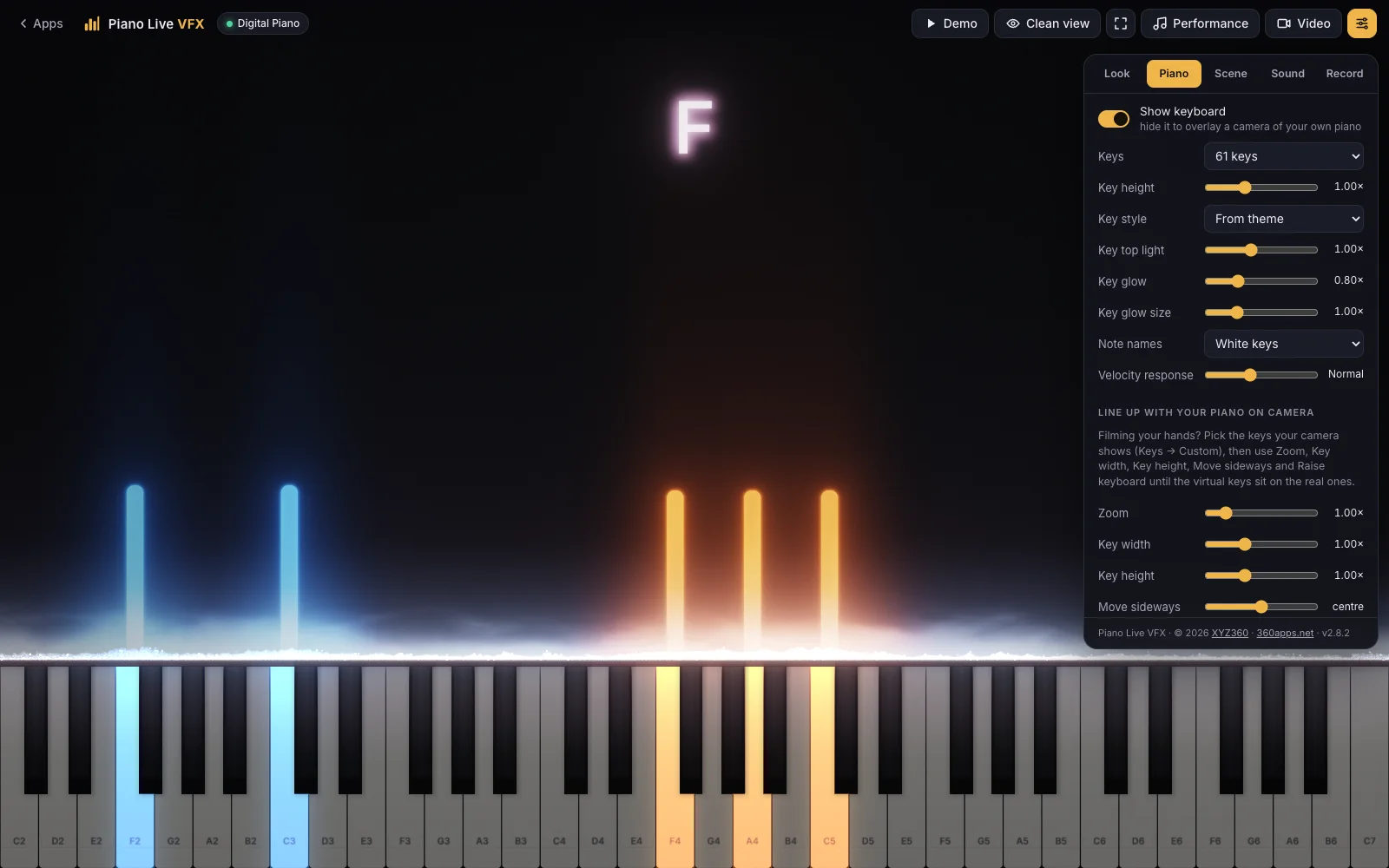 Piano Live VFX in the Studio theme on 61 keys with note names on the white keys, the chord name F above the music, blue bars for the left hand and orange bars for the right hand, and the Piano tab open with the camera line-up controls